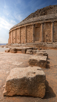 View of the Mausoleum of Mauretania, an ancient royal tomb with its weathered stone facade under a bright blue sky, Tipasa, Algeria.
