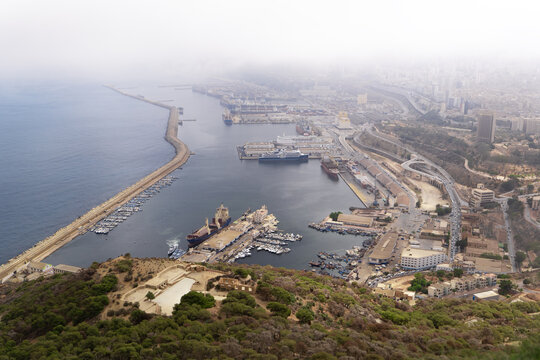 View of the bustling port city where the azure sea meets the urban landscape, a vibrant contrast of maritime activity against the city, Oran, Algeria.