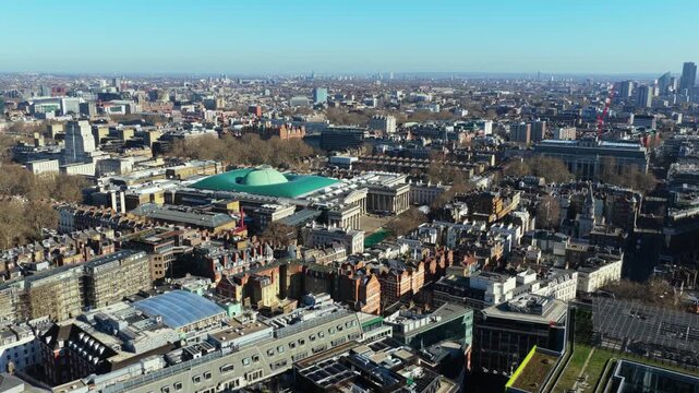 Expansive London cityscape featuring British Museum in Bloomsbury and sprawling urban landscape of Holborn with its mix of modern and victorian architecture under a clear blue sky