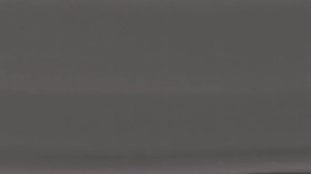 Soft charcoal background with digital noise and signal fluctuation