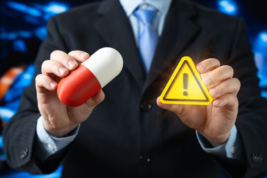 Healthcare alert, medical innovation, urgent health issues, pharmaceutical industry, or the importance of medical decisions. Businessman holding a medical capsule in one hand and an exclamation mark.