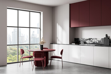 Modern interior kitchen with burgundy dining set beside panoramic window overlooking urban skyline...