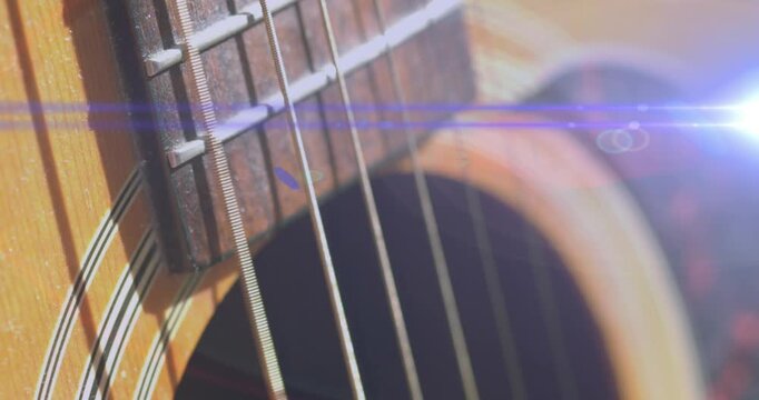 Animation of light flashing over guitar strings moving