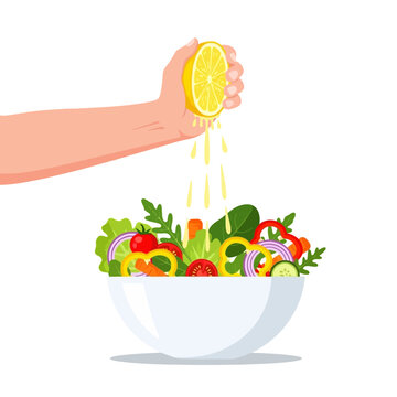 Hand Squeezing Lemon Juice on Fresh Salad Bowl.
