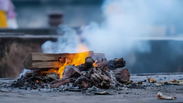 Funeral pyre with rising smoke and glowing embers, traditional cremation ritual, sacred ceremony, cultural heritage, spiritual farewell, solemn atmosphere