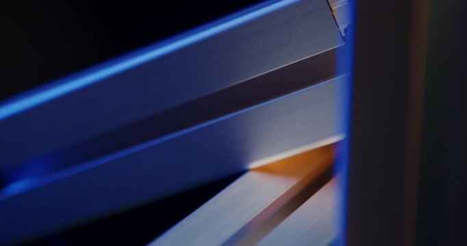 Close up of industrial silver aluminum profile rails in a stack with blue cinematic lighting