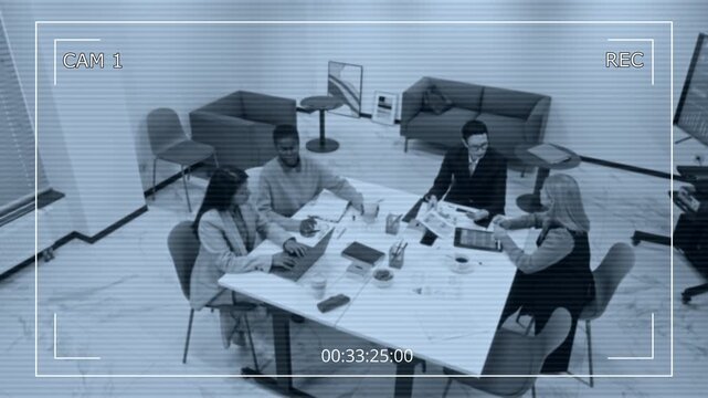 Black and white security camera footage of business meeting in office with multiethnic all female team sitting at table together and collaborating, interface design overlay