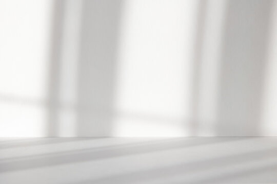 Abstract white studio background with shadows of window. Empty 3d gray room with copy space. Display product with blurred backdrop. Soft focus