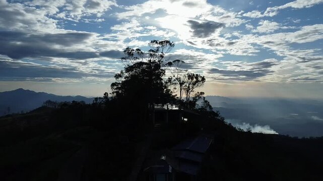  Cinematic aerial reveal early morning drone pull back from Lipton&rsquo;s Seat, Haputale. Golden sunrise glow over clouds.
