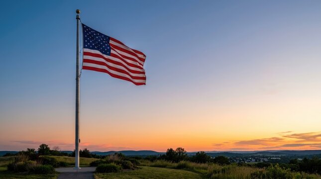American flag waving at sunset
