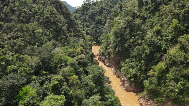 Aerial Drone View of a Red Rock Mountain Canyon Surrounded by Dense Amazon Rainforest Vegetation in Madidi National Park, Rurrenabaque, Bolivia.