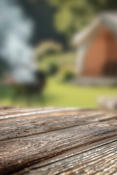 Empty wooden table with copy space and blurred nature  background &ndash; summer outdoor lifestyle concept. Vacation time, camping and enjoying nature. Perfect for food advertising and lifestyle marketing.