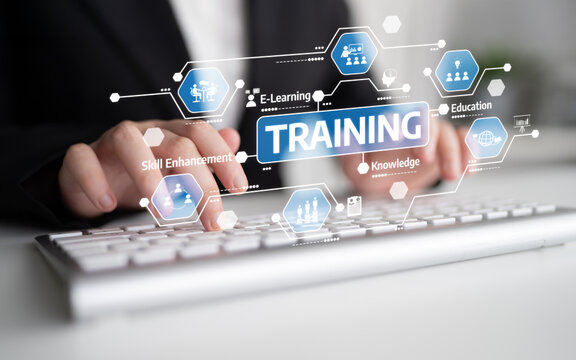 A focused business professional participates in an e-learning training session using a keyboard, surrounded by graphic elements symbolizing knowledge and skill enhancement. Tessel