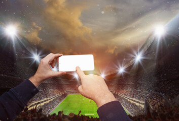  Hands holding smartphone with blank screen on epic soccer stadium with participants glowing. ready for game
