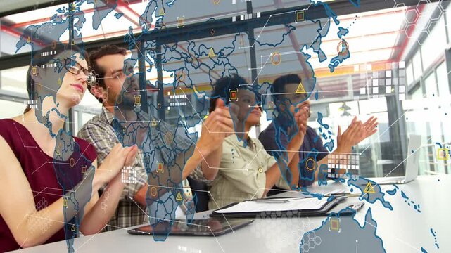 Animation of world map with icons over happy diverse female and male coworkers clapping hands