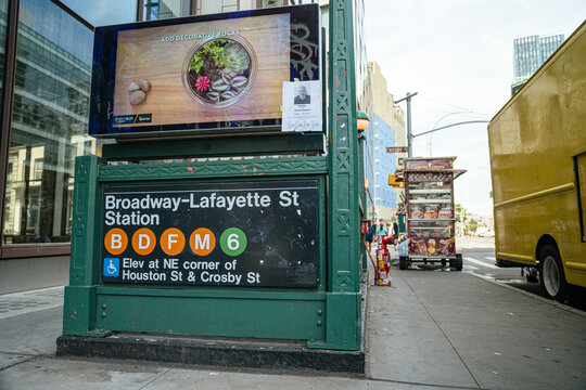 New York City, New York, USA - 08.03.2024: Broadway Lafayette Street subway station sign with B D F M and 6 train lines in Manhattan, New York City. Street level metro entrance surrounded by urban