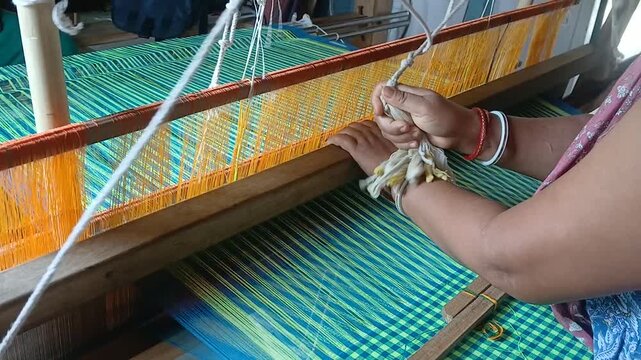 Handloom weaver in India working in her loom.