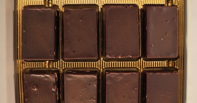 Chocolate bar display in a box on a white background for sweet treat lovers