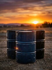 Obraz premium Metal oil barrels standing in field at sunset. Industrial containers for petroleum storage. Energy sector logistics and crude fuel distribution concept in countryside landscape scenery.