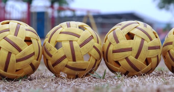 Sepak takraw balls are used for training on the ground.