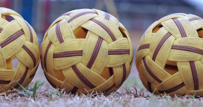 Sepak takraw balls are used for training on the ground.