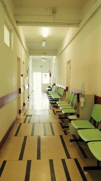 Walking through empty hospital corridor clinic healthcare interior b roll vertical video
