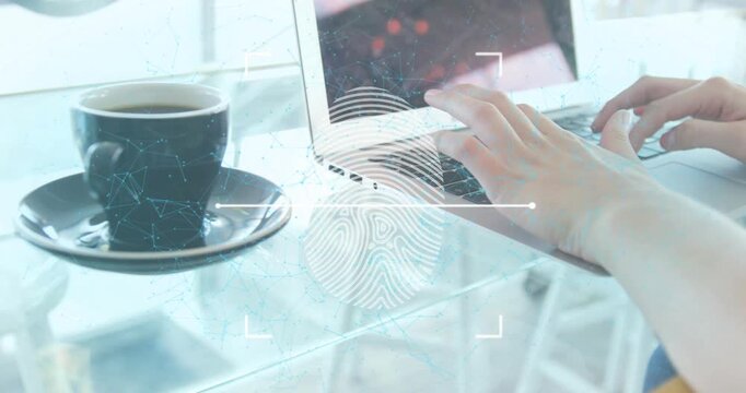 A woman using a laptop with a coffee cup on a table in a restaurant