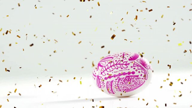 Animation of confetti over easter egg with pattern on white background at easter