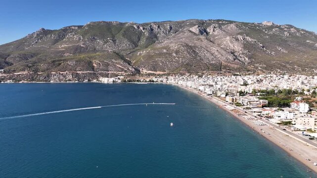 Aerial drone cinematic video of famous seaside area, organised beach and bay of Loutraki town, Corinthian bay, Greece