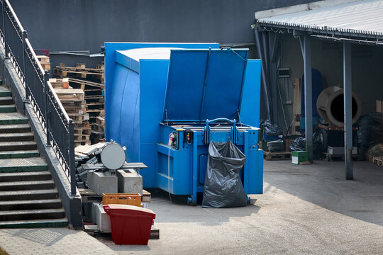 Press Container waste Compactor machine for Reducing Volume in yard of large hypermarket mall. Press Container Compactor for Reducing Volume of Municipal and Industrial Waste. Waste recycling concept.