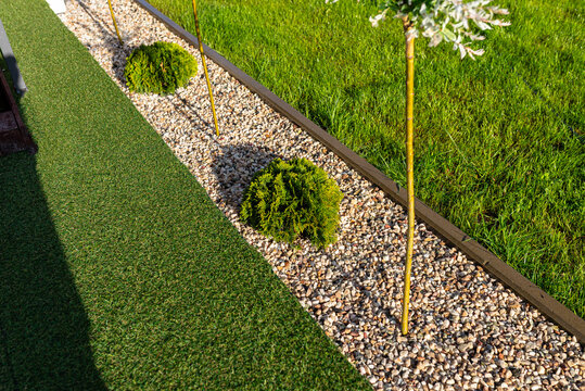 Garden landscaping with gravel band separating grass areas