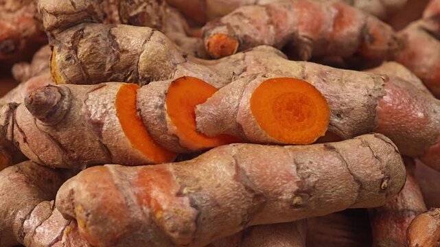Fresh turmeric roots on wooden