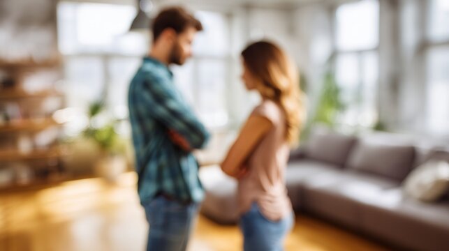 Unhappy couple turning backs after argument at home, blurred man and woman facing away in silent tension