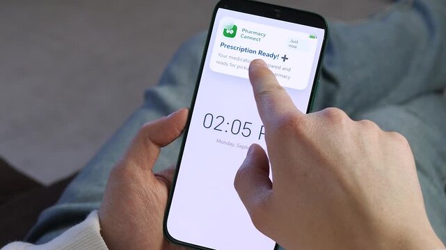 Close-up of a person receiving a pharmacy pickup alert on their phone. Modern digital healthcare concept showing medication readiness. Perfect for health tech commercials, telemedicine ads, and