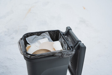 Public Waste Container Filled With Paper And Plastic Items For Collection. Streetside Waste Bin Loaded With Paper Plates And Plastic Cups Ready For Routine Collection Today © Aleksey
