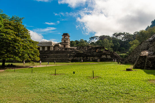 Ancient stone temple stands tall beneath a bright blue sky