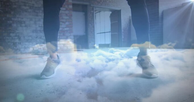 Animation of clouds over african american sportsman at gym
