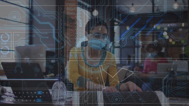 Animation of data processing over businesswoman using laptop at office