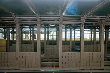 Fototapeta premium A wide view of steel beams and subway tracks inside an underground tunnel in Manhattan. The New York City metro infrastructure reveals industrial architecture and railway engineering.