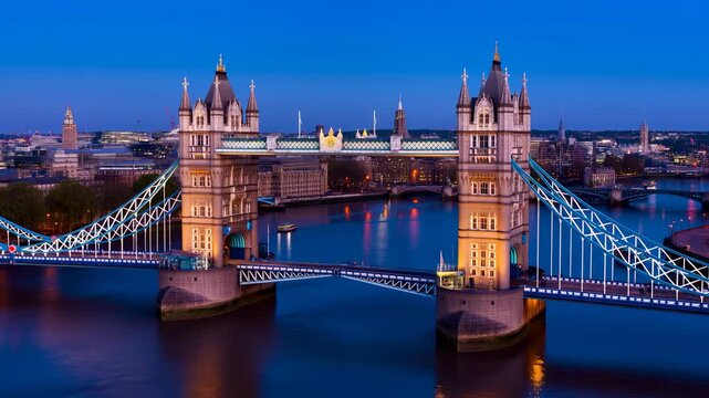 Nighttime Thames With Illuminated Cables. Historic Bridge Lights Reflected In Tranquil River