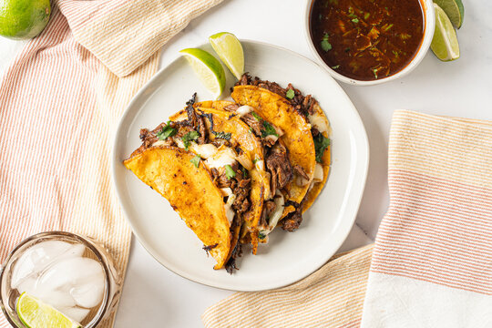 Birria tacos. Mexican food made with beef and a dipping sauce