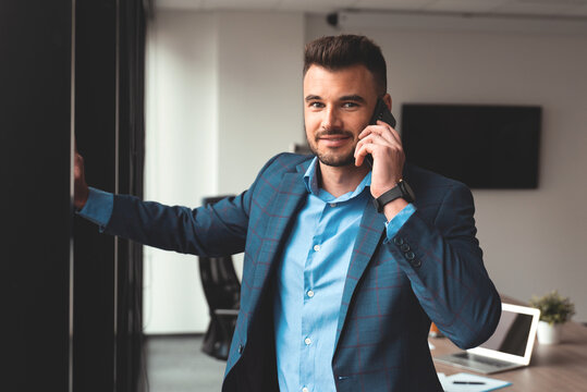 Portrait of a businessman in the office with phone