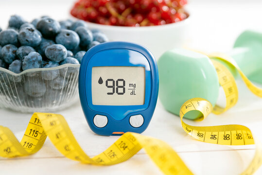 Glucometer and vegetables on desk