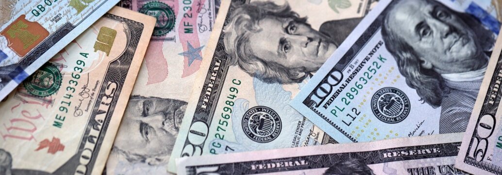 Big pile of US dollar bills in various nominations. United States money banknotes