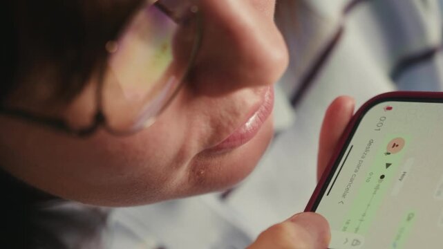 A woman uses her smartphone to communicate by recording and dictating voice messages. Modern digital communications and everyday life. High quality 4k footage