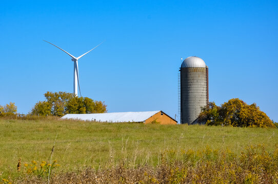 Windmill, silo and barn in the field