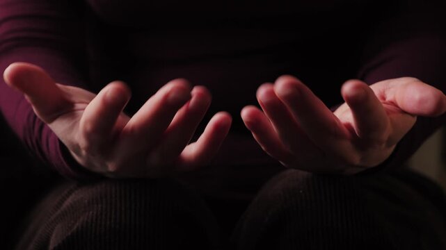 A close up of a speaker's hands actively gesturing during a conversation. The expressive hand movements emphasize the emotions and engagement in the discussion. High quality 4k footage