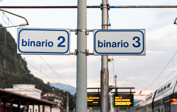 Signage indicating platforms 2 and 3 at Laveno Mombello railway station, located in the province of Varese, Lombardy, Italy. Public transport infrastructure and travel concept.