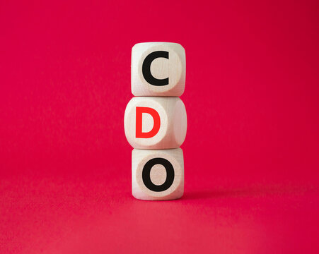 CDO - Collateralized Debt Obligation symbol. Wooden cubes with word CDO. Beautiful red background. Business and Collateralized Debt Obligation concept. Copy space.