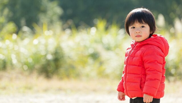 Child in red jacket outdoors